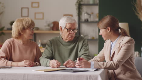 Elderly-Couple-and-Financial-Advisor-Posing-for-Camera-with-Smile